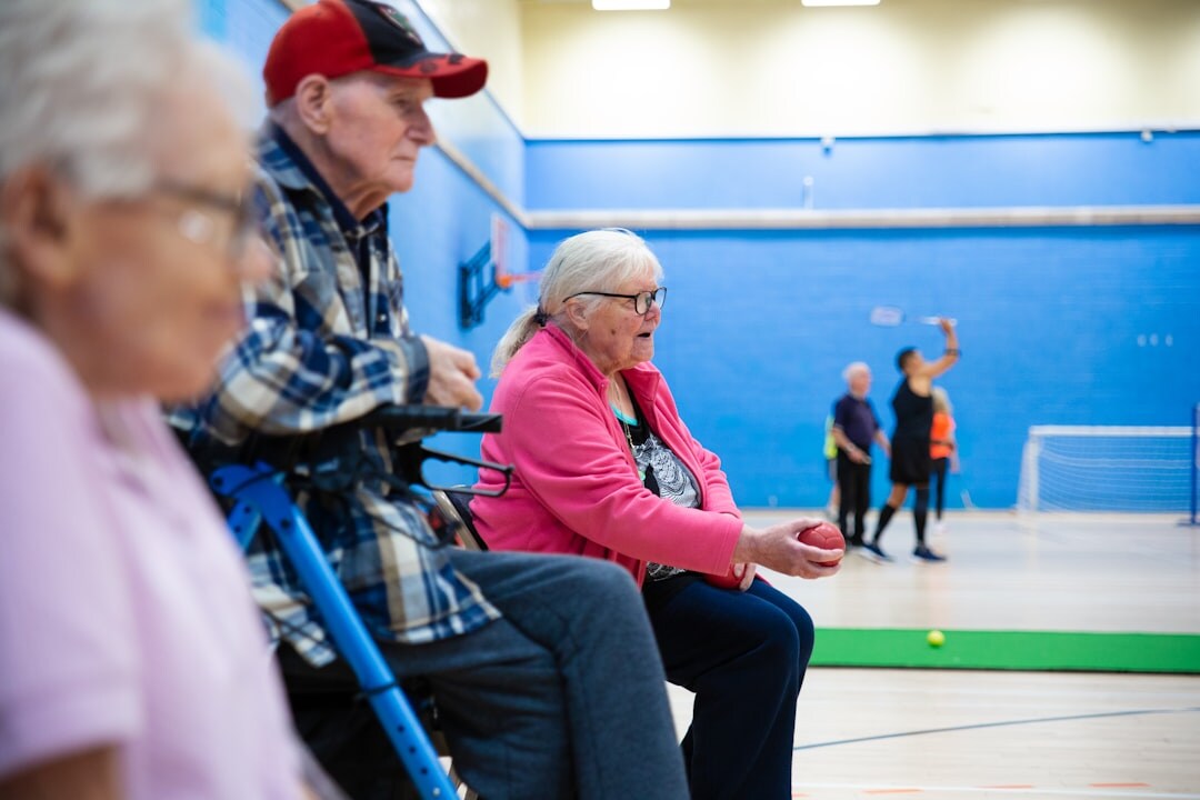 Senior couples dancing together in a community hall during a social dance event