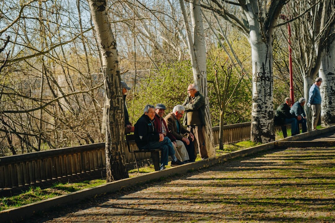 Group of active Slovak seniors laughing together outdoors during a community walk