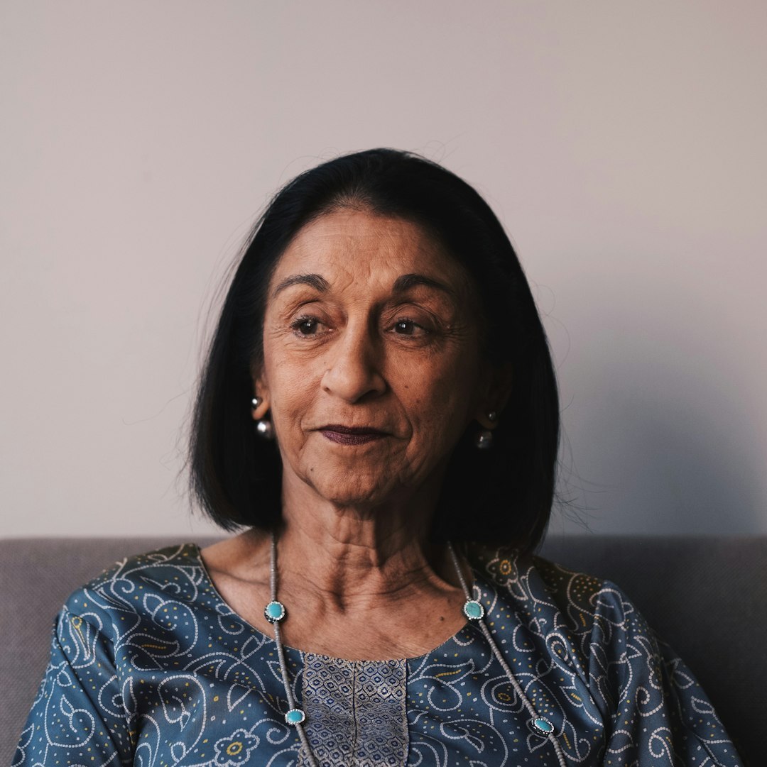 Portrait of a friendly older woman volunteer coordinator smiling